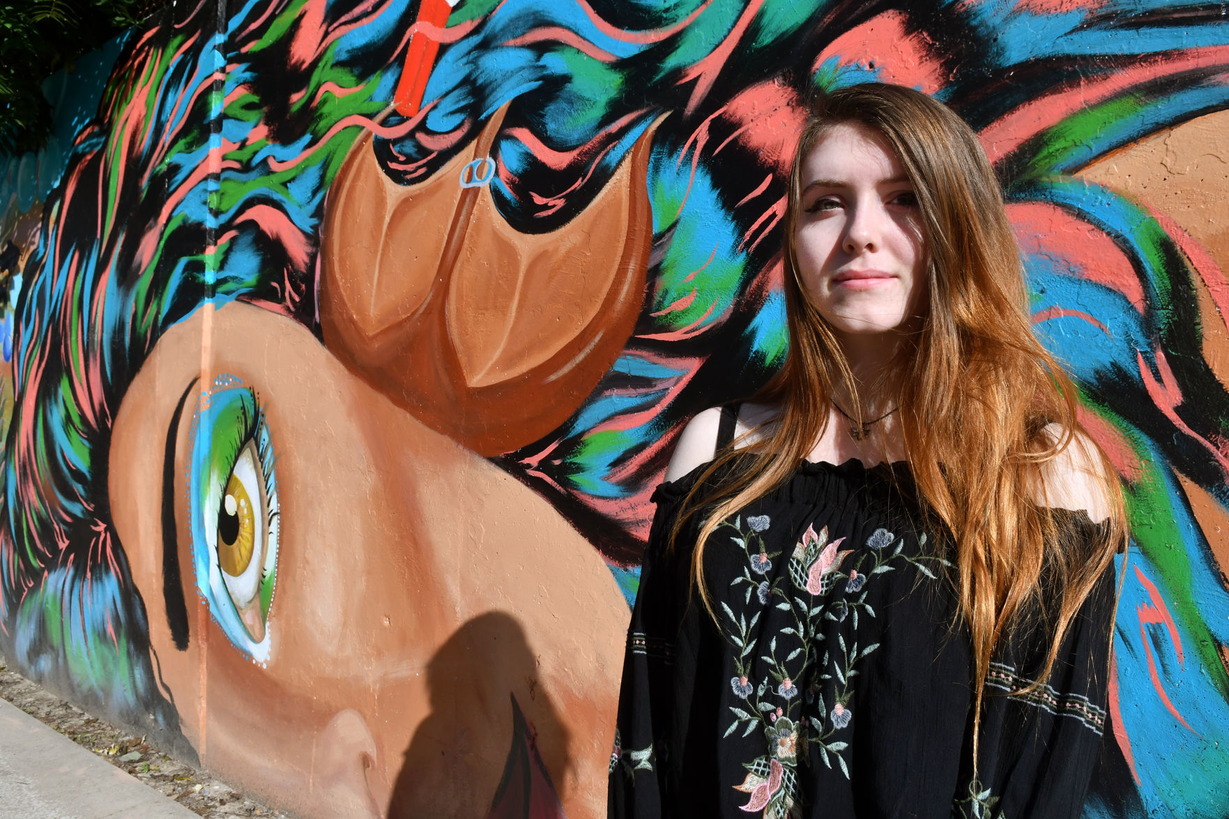 Madelynn Vogt artist of mermaid face on mural at Lincoln Road and 18th Street in Bettendorf.
